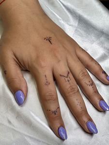 Delicate finger constellation tattoos