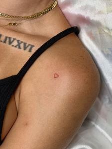 Micro red heart on the shoulder with roman numerals