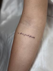 Tiny single-line script on the arm